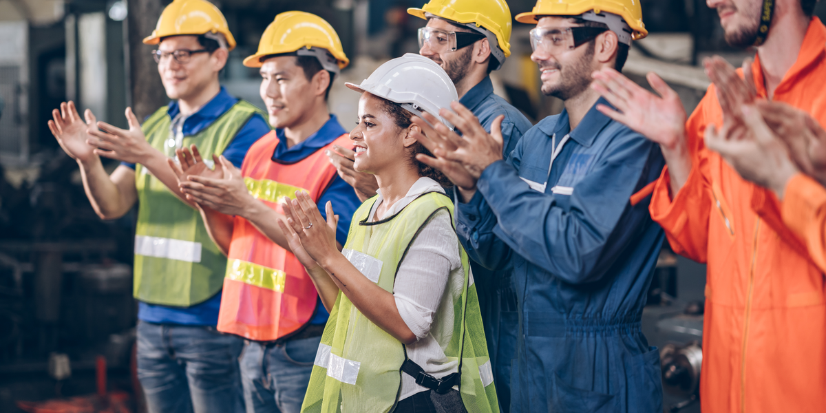 blue-collar workforce clapping and happy at the workplace